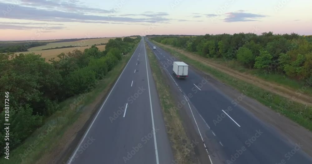 Aerial: Flying Above Container Semi Truck Transporting Goods On Busy Highway Aerial: Flying Above Container Semi Truck Transporting Goods On Busy Highway