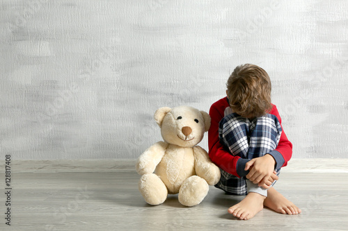 Sad little boy with teddy b...
