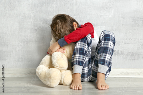 Sad little boy with teddy b...