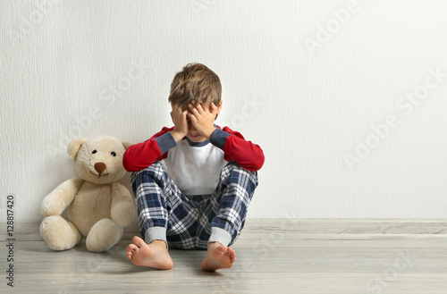Crying little boy with tedd...