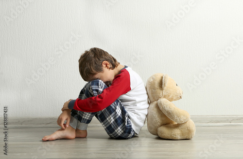 Sad little boy with teddy b...