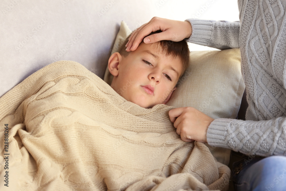 Woman and small sick boy in bed Woman and small sick boy in bed