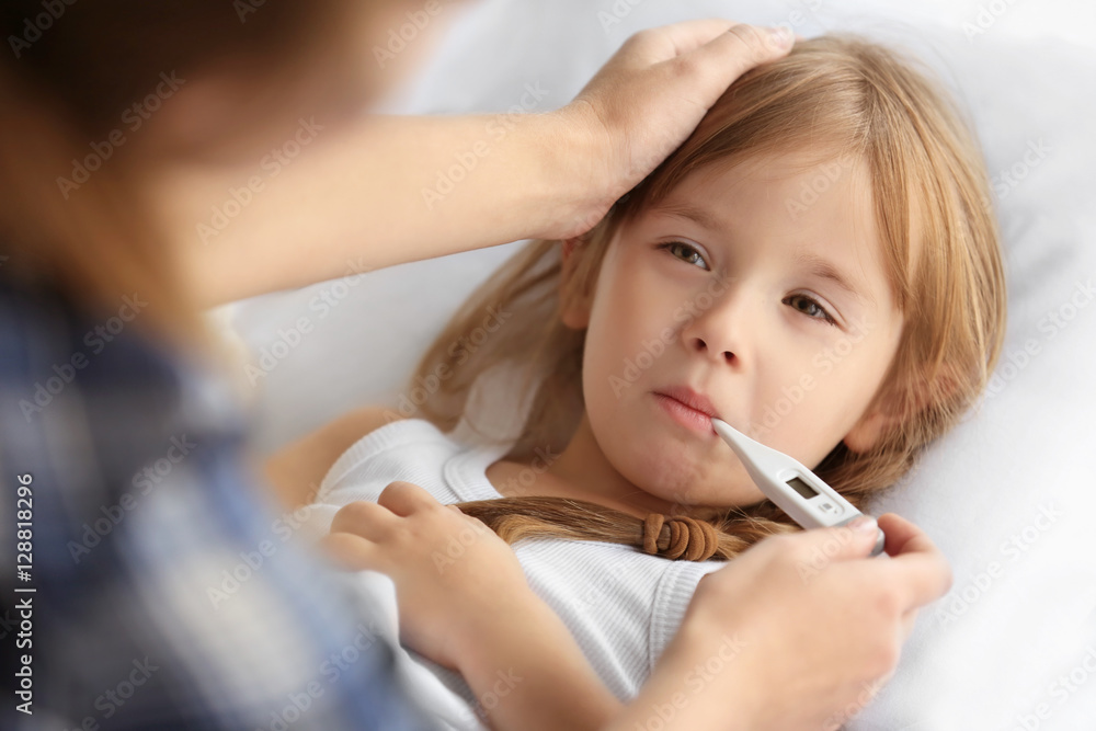 Woman measuring temperature of small sick girl Woman measuring temperature of small sick girl
