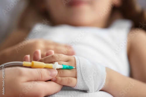 Little sick girl with cathe...
