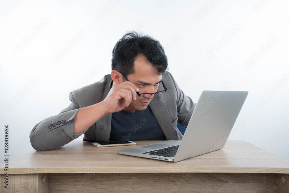 young businessman Stressful jobs using a laptop sitting thinking young businessman Stressful jobs using a laptop sitting thinking