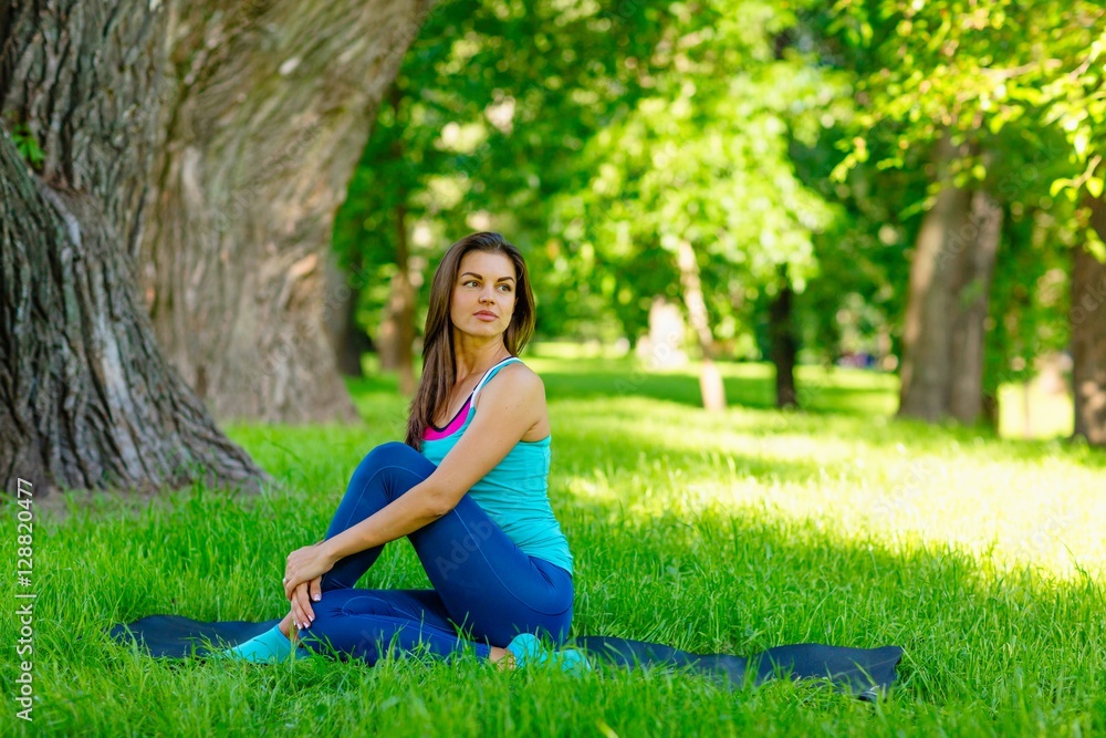 Yoga woman on green grass 