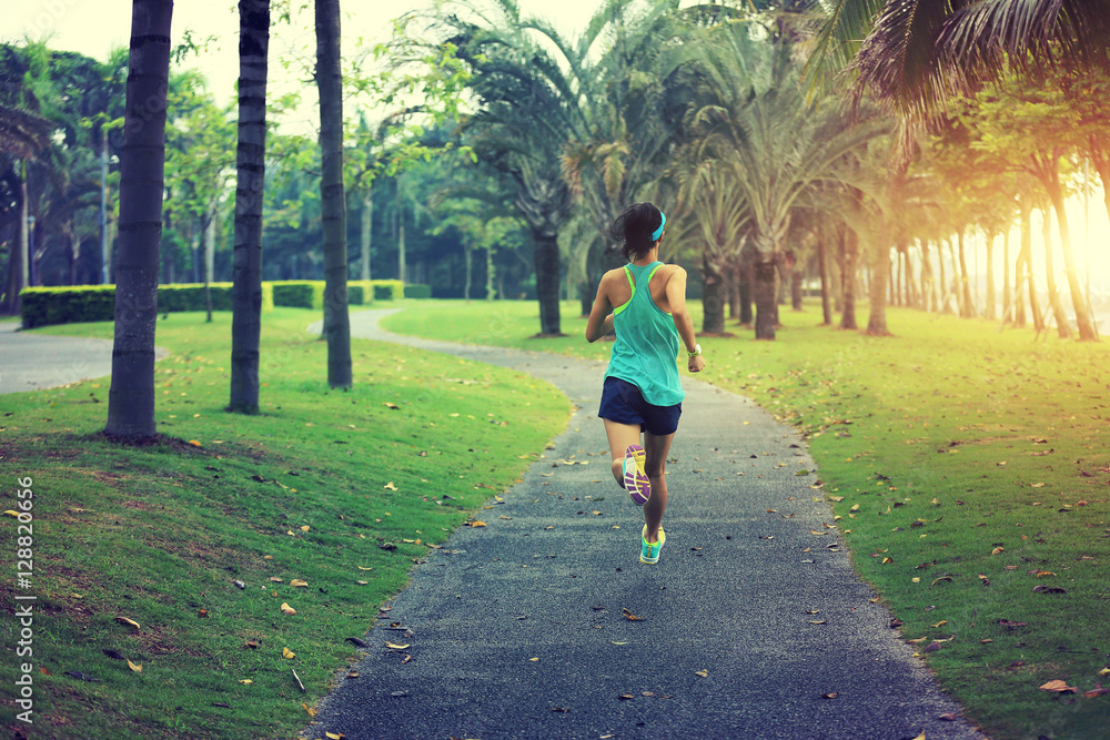 healthy lifestyle young sporty asian woman running at tropical park healthy lifestyle young sporty asian woman running at tropical park