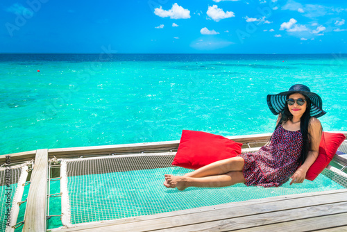 Portrait of happy young woman at beautiful water villa at Maldiv