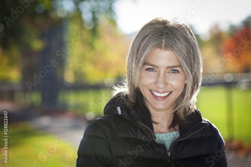 Portrait Of A Mature Woman Smiling At The Camera. Outside. © annawin