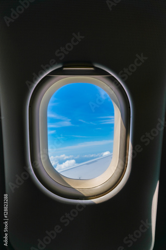 Plane window with cloud view .