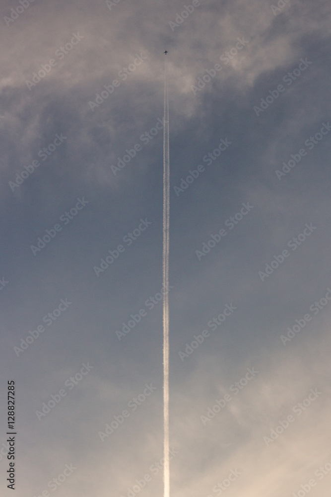 Airplane trail straight twilight sky Airplane trail straight twilight sky