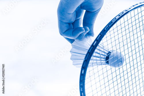 Badminton sport start playing, closeup hand serve badminton shuttlecock in badminton court. photo