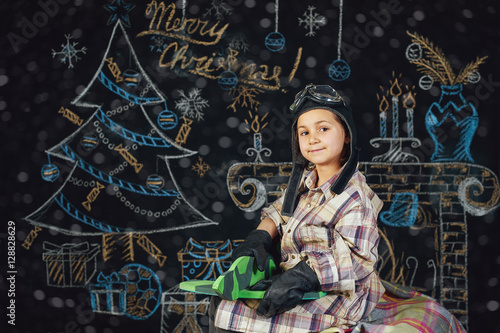 girl playing with a model airplane on a Christmas background