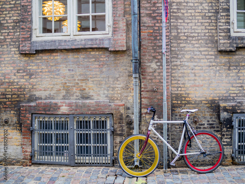 Photography Bicycle with colorful wheels, parking outside the building