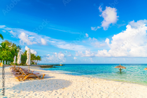 Fototapeta Naklejka Na Ścianę i Meble -  Beach chairs with umbrella at Maldives island, white sandy beach