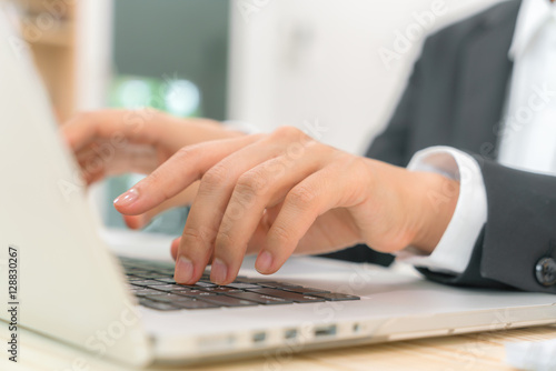 Closeup of business woman hand typing on laptop keyboard . © jannoon028
