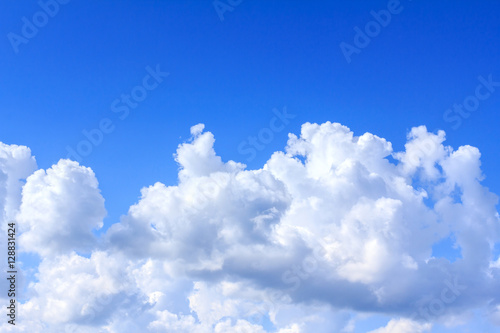 Blue sky background with white clouds and rain clouds.
