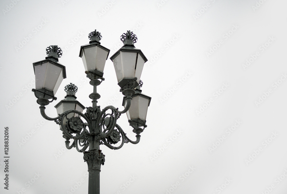 Dark vintage filtered on street lamps with grey sky background