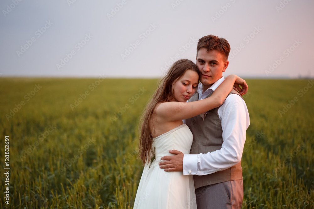 Beautiful wedding couple posing at the nature Beautiful wedding couple posing at the nature