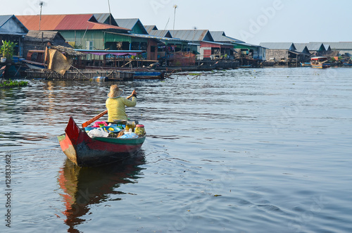 Asia woman selling product while boating on the canel or river in Tonle Sap Cambodia