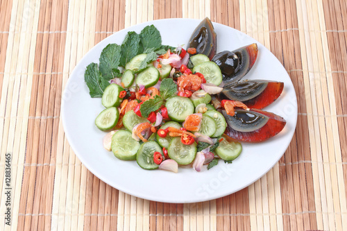 Spicy cucumber salad with dried shrimp and preserved egg.