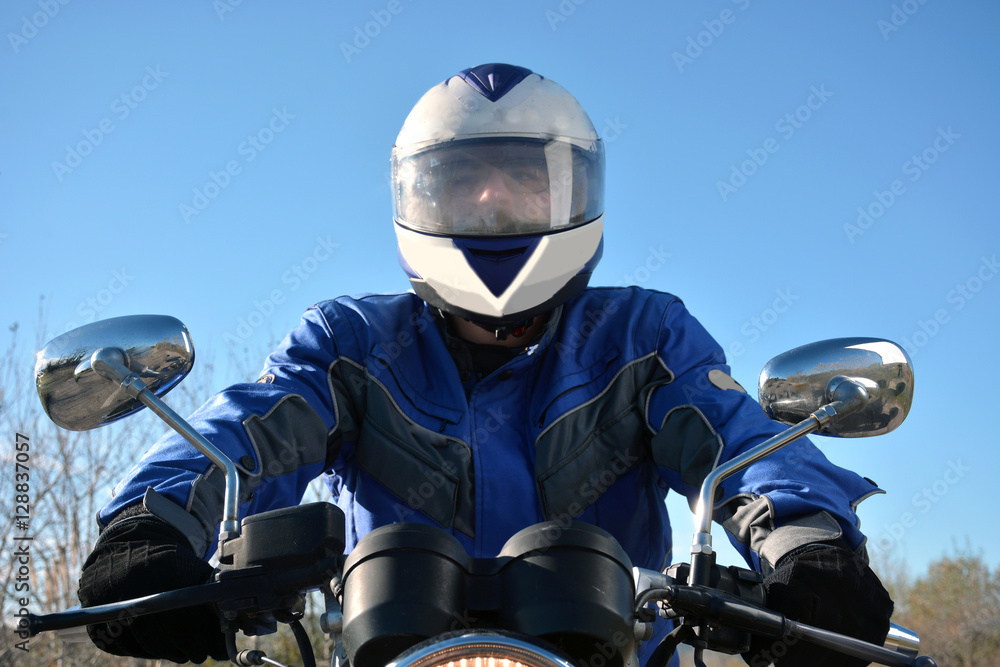 biker with helmet blue going by a road biker with helmet blue going by a road