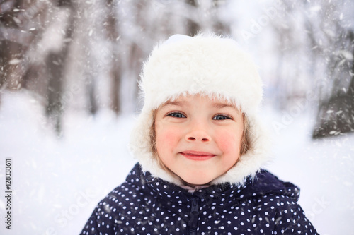 Portrait of a cute little girl in snowy weather.