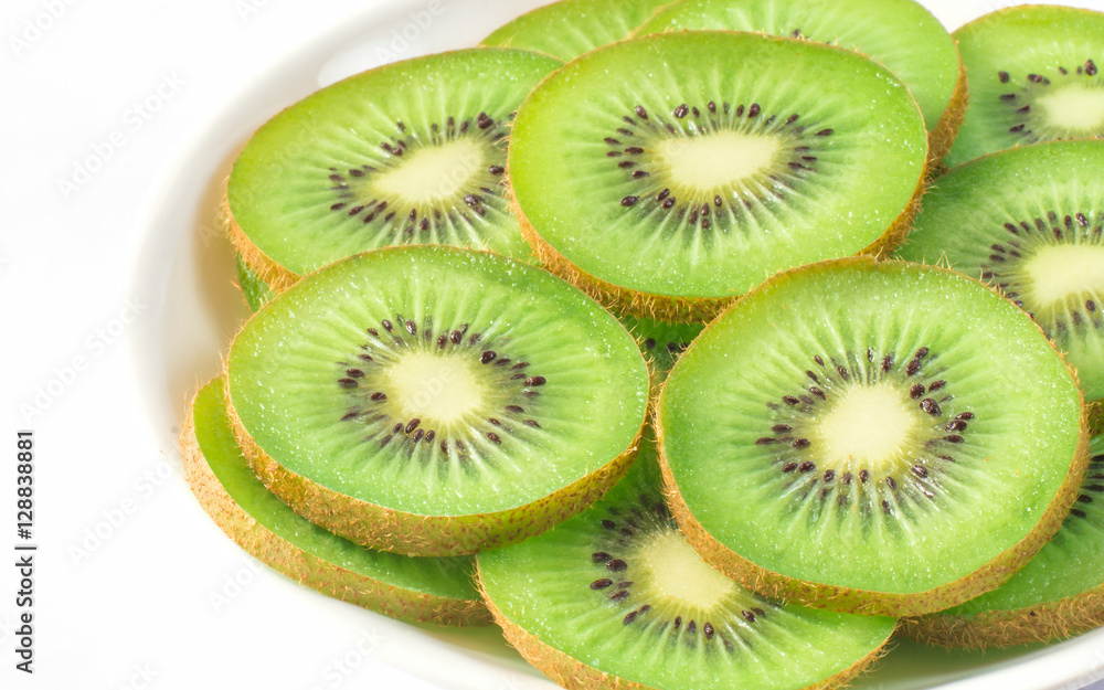 Kiwi on a white plate on a white background Kiwi on a white plate on a white background