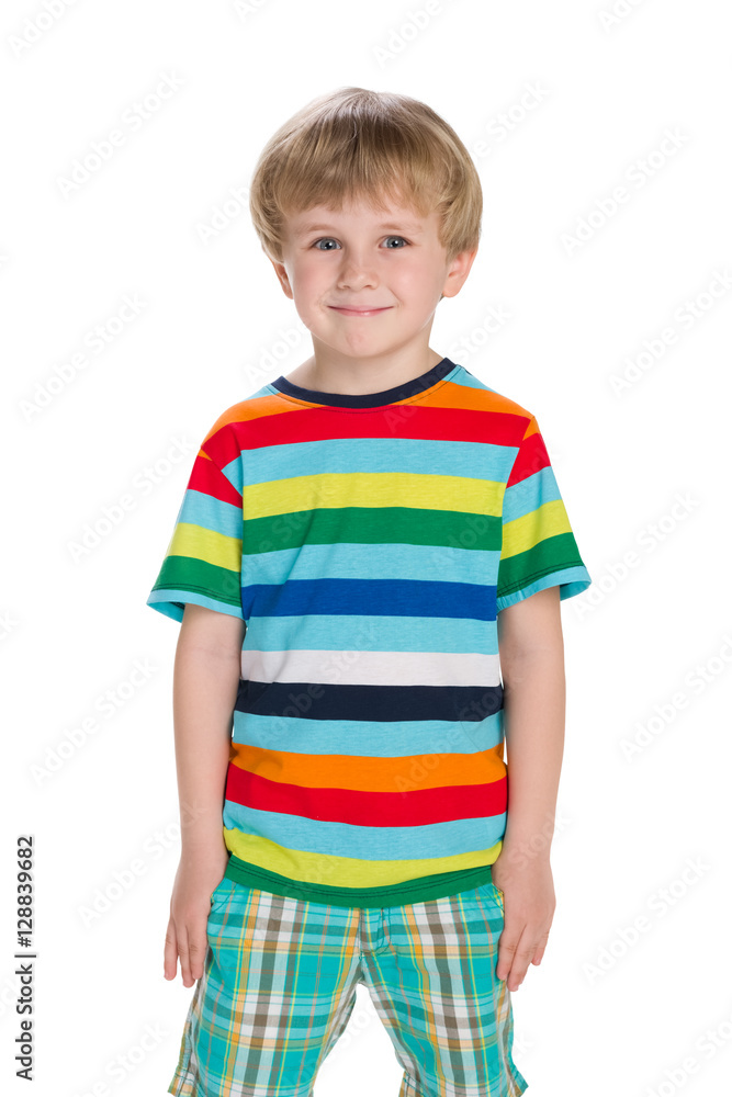 Blond little boy stands against the white Blond little boy stands against the white
