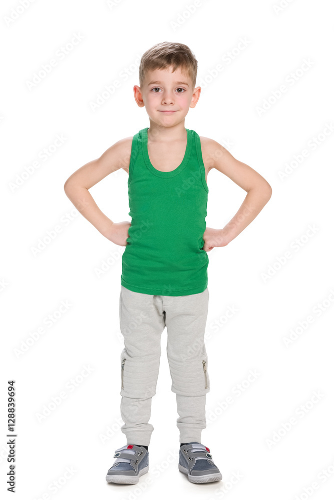 Confident little boy stands against the white Confident little boy stands against the white