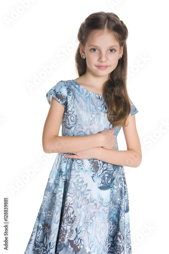 Cute little girl stands against the white