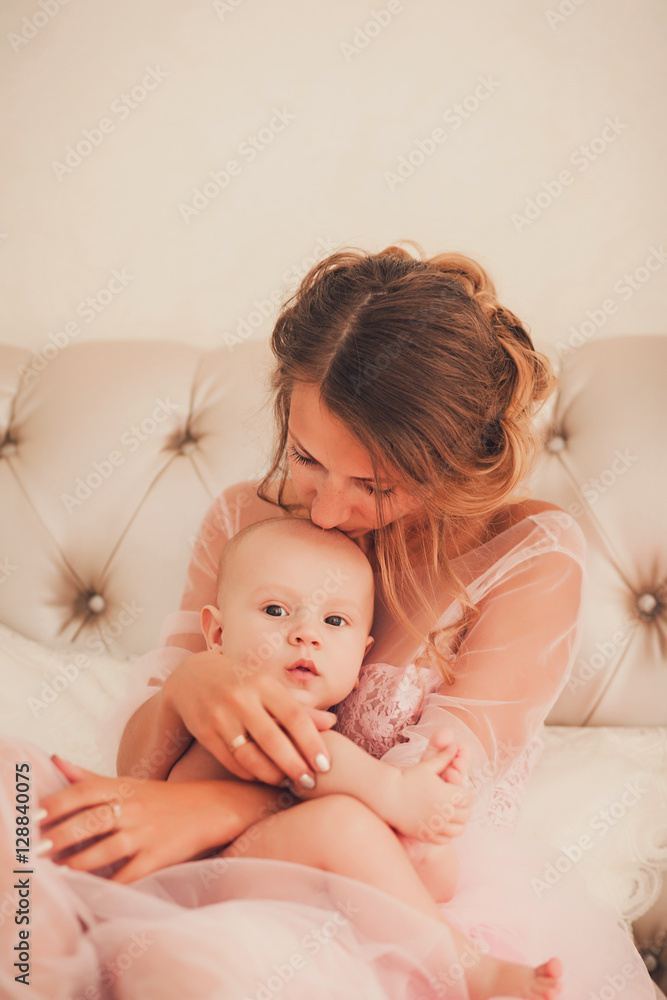 Mom kissing baby boy in bedroom Mom kissing baby boy in bedroom