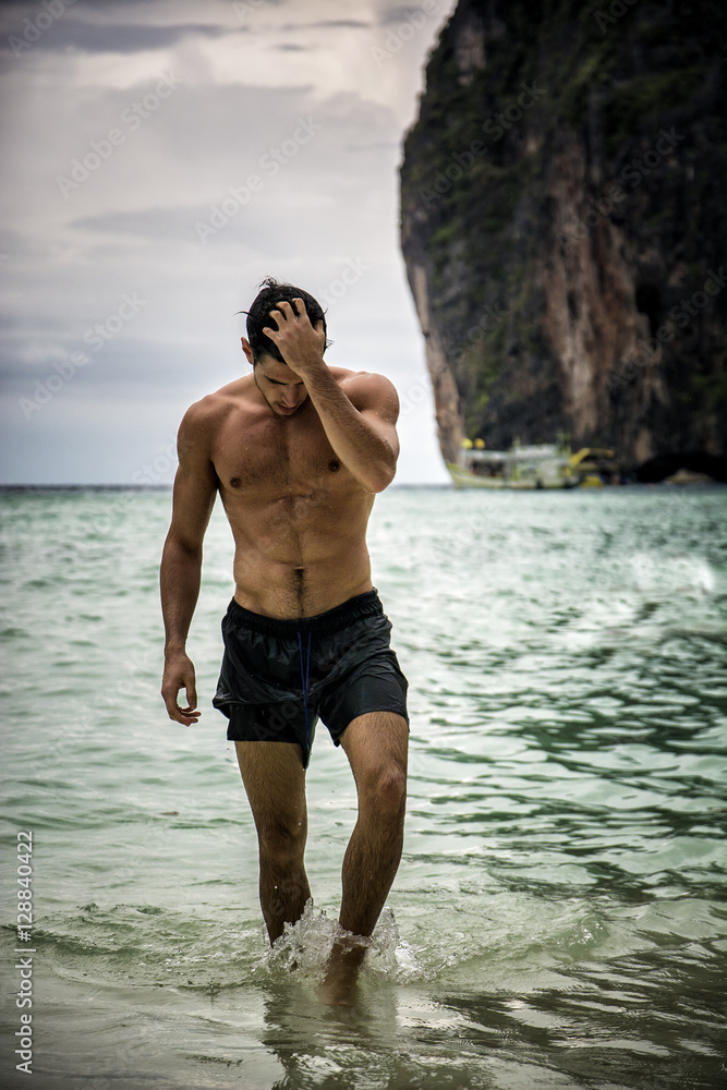 Half body shot of a handsome young man standing on a beach in Phuket  Island, Thailand, shirtless wearing boxer shorts, showing muscular fit body  Photos | Adobe Stock