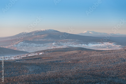 Distant view of the Ural town with winter mountains, Russia