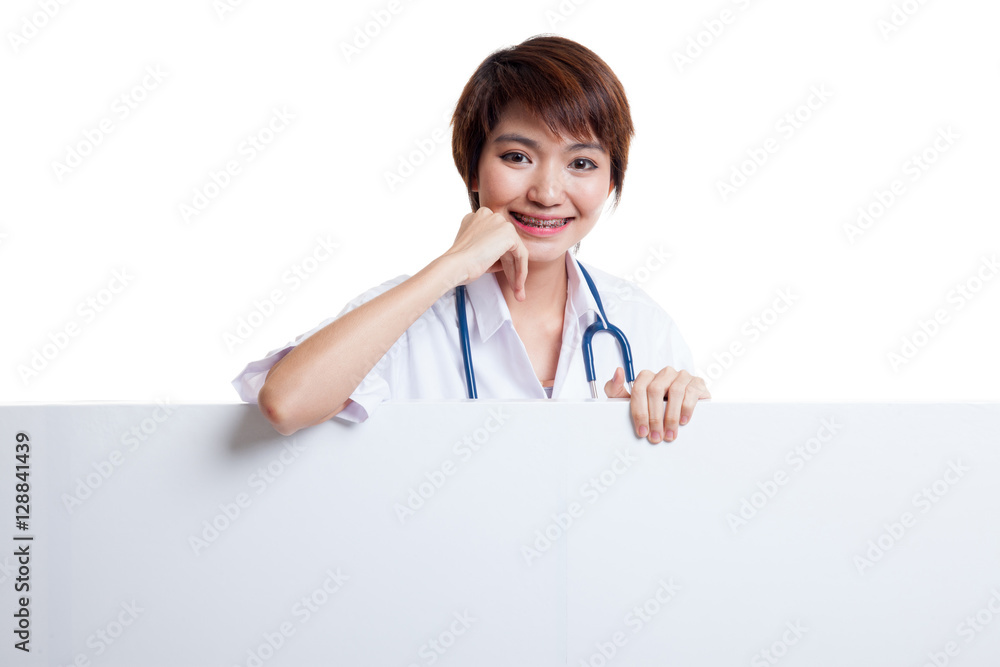 Young Asian female doctor standing behind blank white billboard. Young Asian female doctor standing behind blank white billboard.