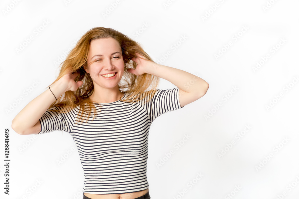 Smiling beautiful caucasian girl with her hands touching hair Smiling beautiful caucasian girl with her hands touching hair