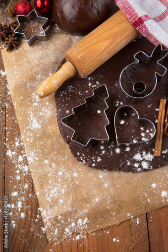 Christmas baking background with gingerbread dough, cookie cutters and spices. Winter holiday concept.