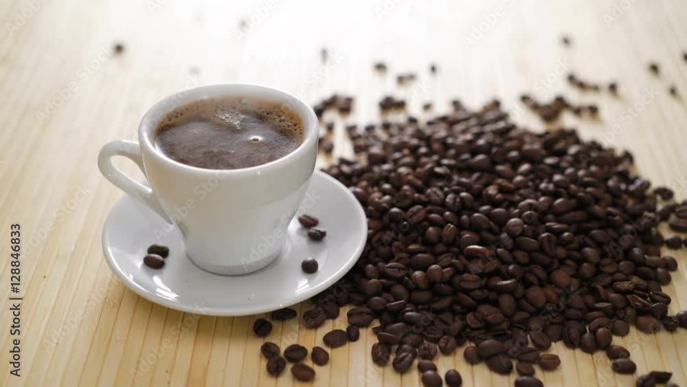 A white cup of evaporating coffee on the table with roasted beans in 4K A white cup of evaporating coffee on the table with roasted beans in 4K