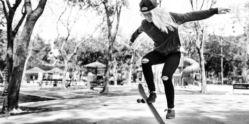 Young Woman Jumping Olly Skateboard Concept
