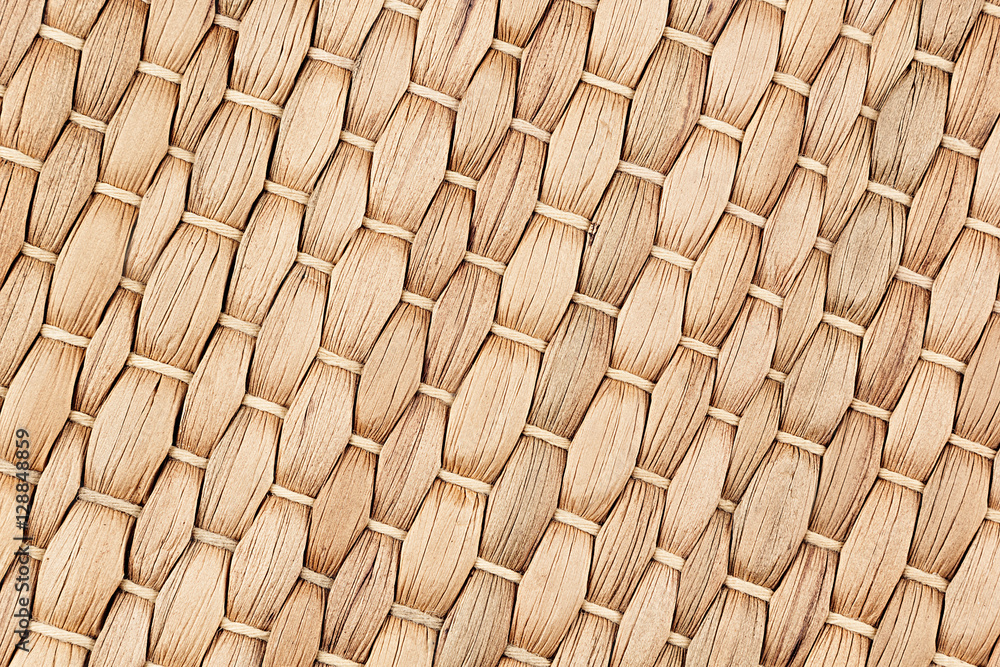 Fototapeta premium Bamboo woven beige mat handmade background. Wicker wood texture. Diagonal strips.