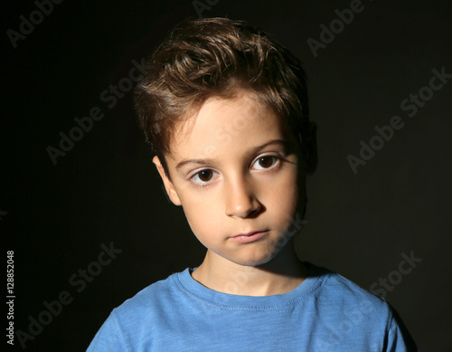 Cute little boy on black ba...