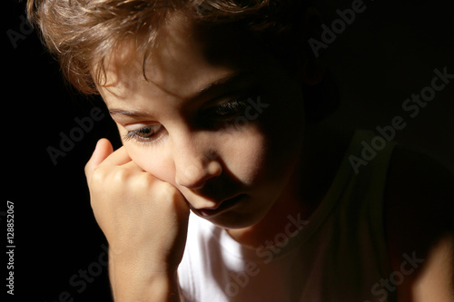 Cute little boy on black ba...