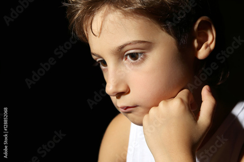 Cute little boy on black ba...