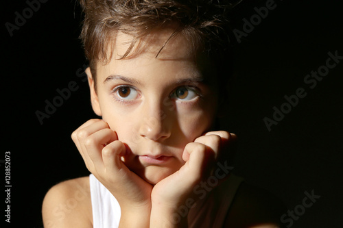 Cute little boy on black ba...