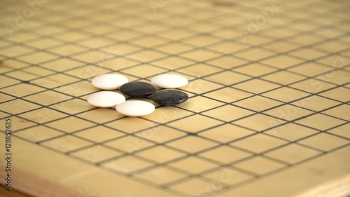 Chinese go game weiqi playing on wooden board