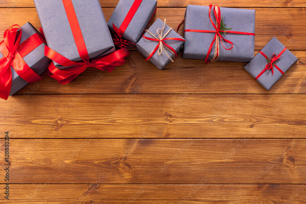 Fototapeta premium Presents in gift boxes on wood frame background