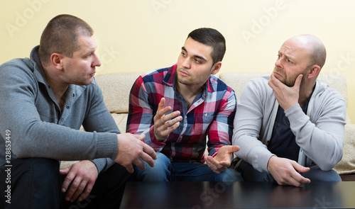 Guys sharing problems at the table