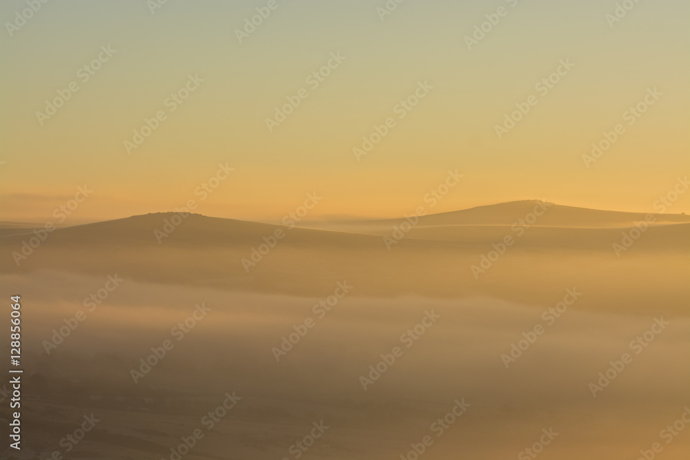 Sunrise over Dartmoor with Tors in view like sand dunes, Devon, UK