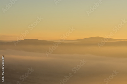 Sunrise over Dartmoor with Tors in view like sand dunes, Devon, UK