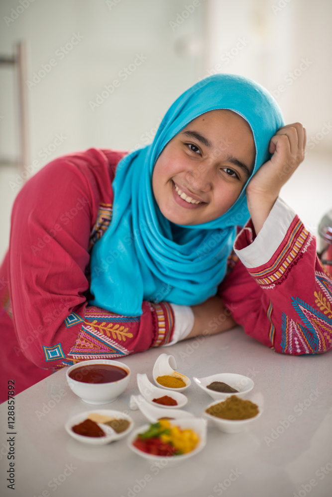 Muslim traditional woman working in kitchen Muslim traditional woman working in kitchen